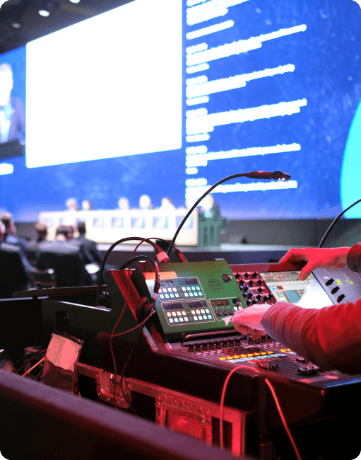 Hands using sound dashboard at conference event