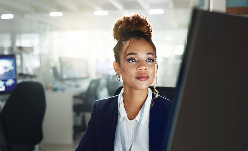 Businesswoman looking at screen analyzing data.
